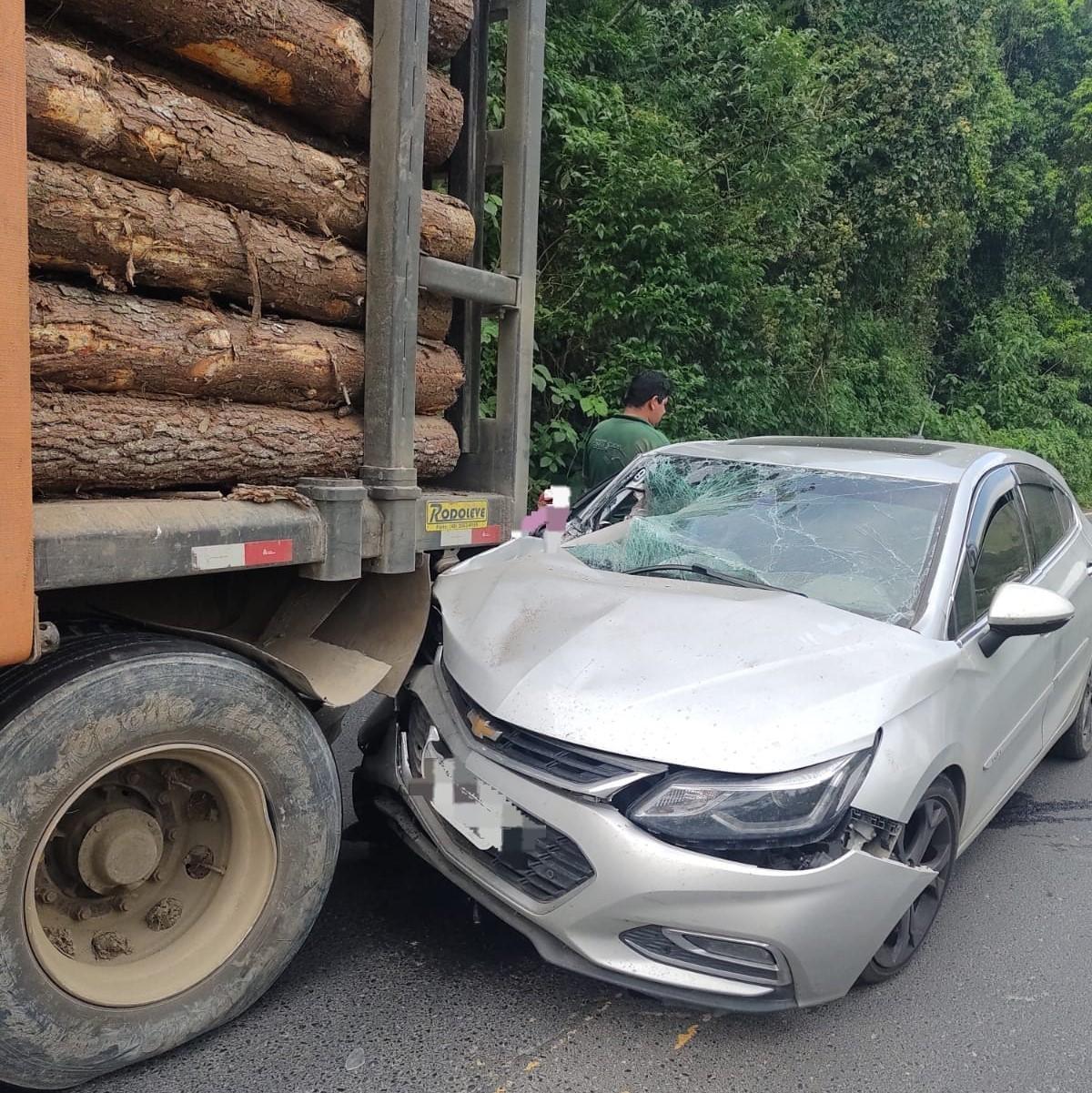 Colisão entre carro e caminhão carregado com toras deixa duas pessoas feridas